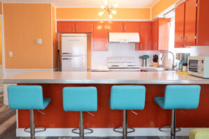 image of turquoise bar stools in kitchen in two bedroom deluxe suite at Upper Deck Hotel in South Padre Island